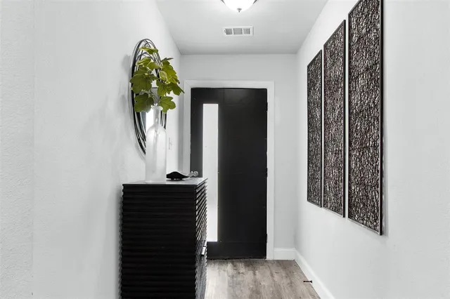 an entryway with a mirror