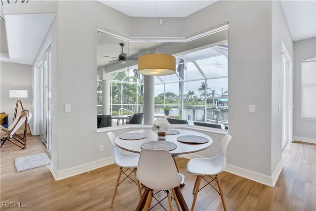 a dining room with furniture a chandelier and wooden floor