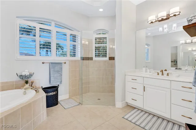 a bathroom with a granite countertop sink mirror bathtub and shower