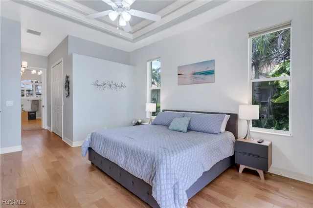 a spacious bedroom with a bed and a large window