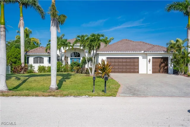 a front view of a house with a garden and yard
