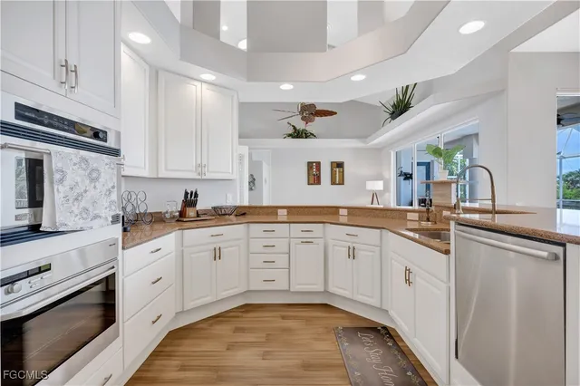 a large kitchen with cabinets a sink and appliances