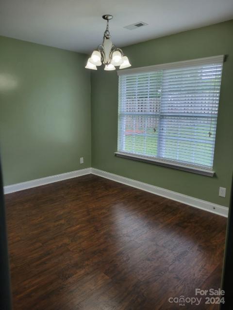 300 Ashmont Drive Kannapolis, NC 28081 - Photo 11 of 42 an empty room with wooden floor and windows