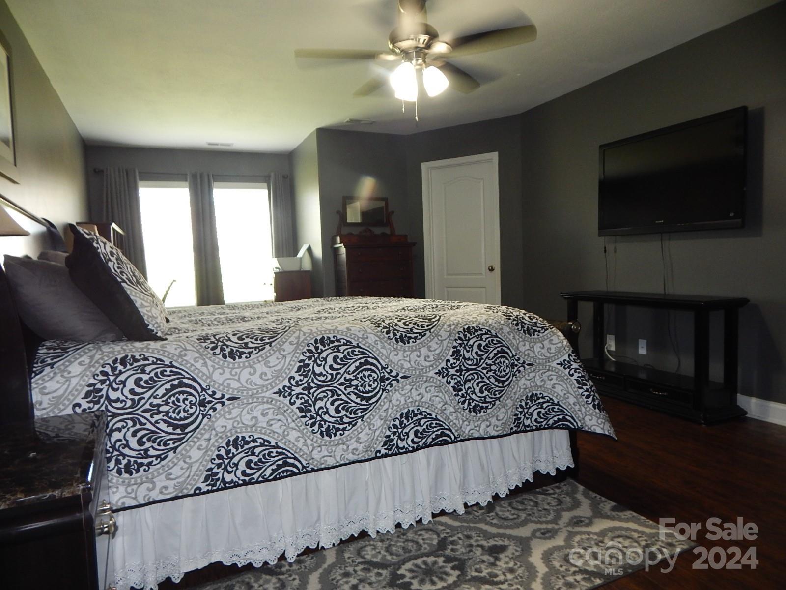 300 Ashmont Drive Kannapolis, NC 28081 - Photo 16 of 42 a bedroom with a bed and a flat tv screen on dresser