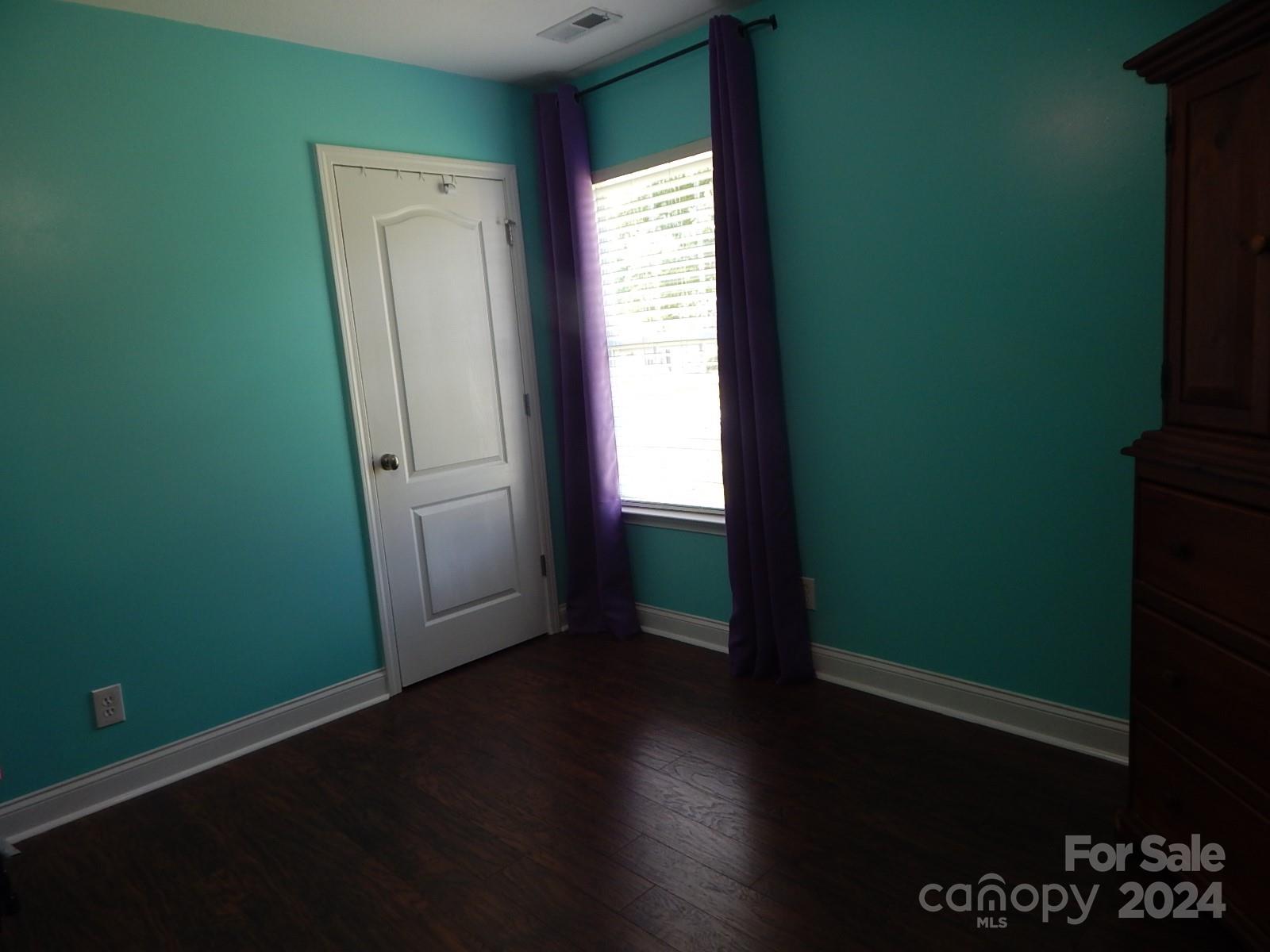 300 Ashmont Drive Kannapolis, NC 28081 - Photo 28 of 42 an empty room with wooden floor and windows