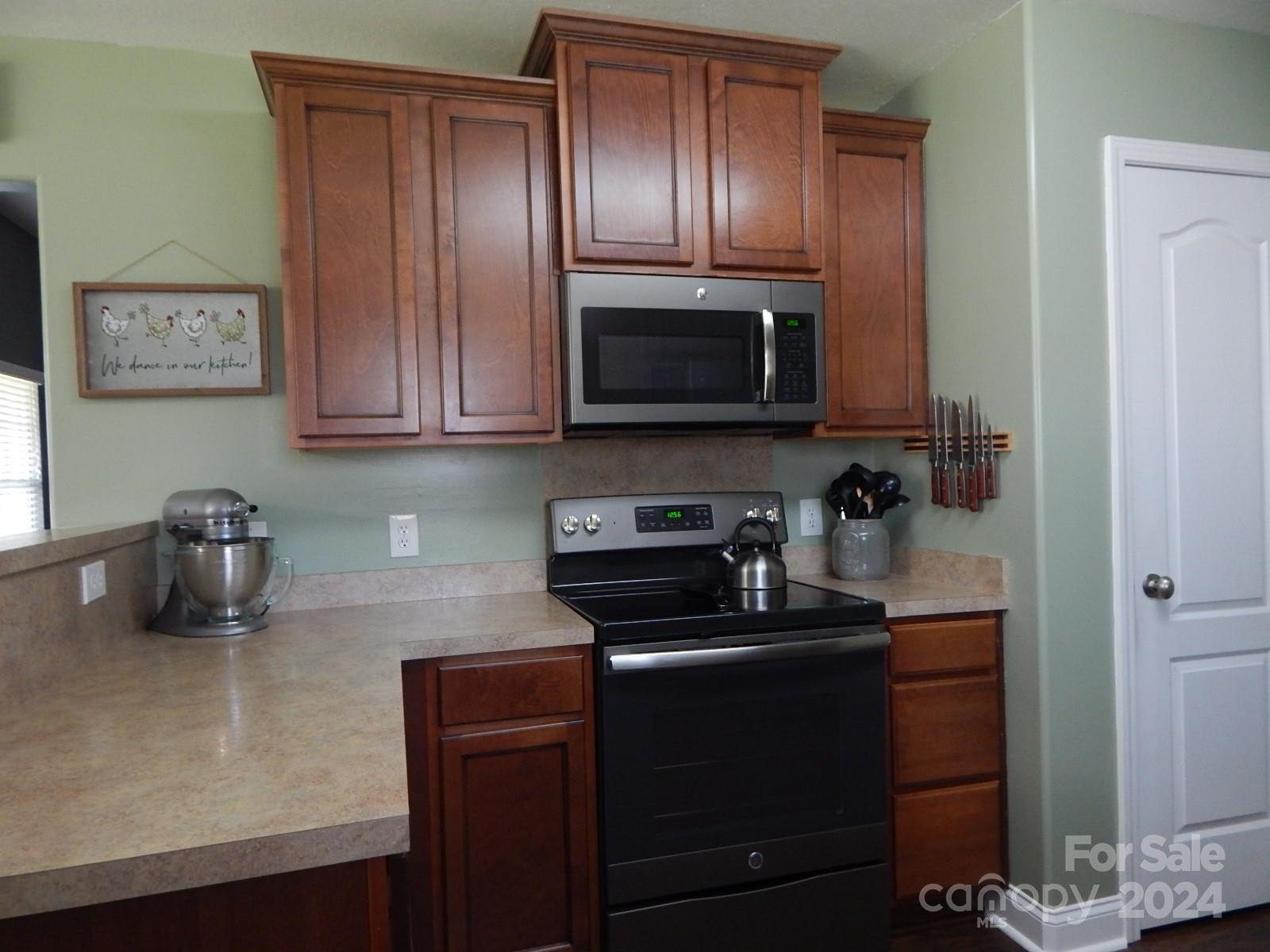 300 Ashmont Drive Kannapolis, NC 28081 - Photo 5 of 42 a kitchen with sink a microwave a stove and cabinets