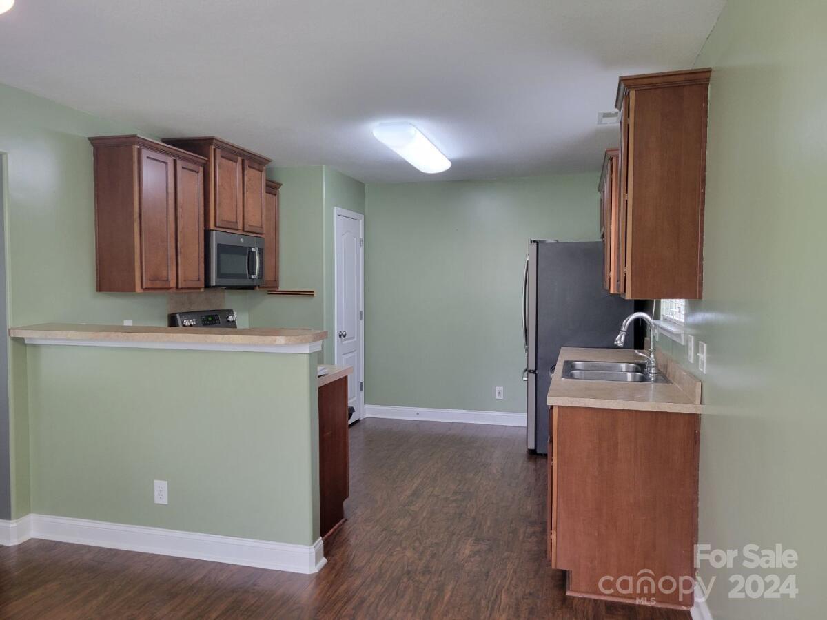 300 Ashmont Drive Kannapolis, NC 28081 - Photo 6 of 42 a room with a sink a washer and dryer