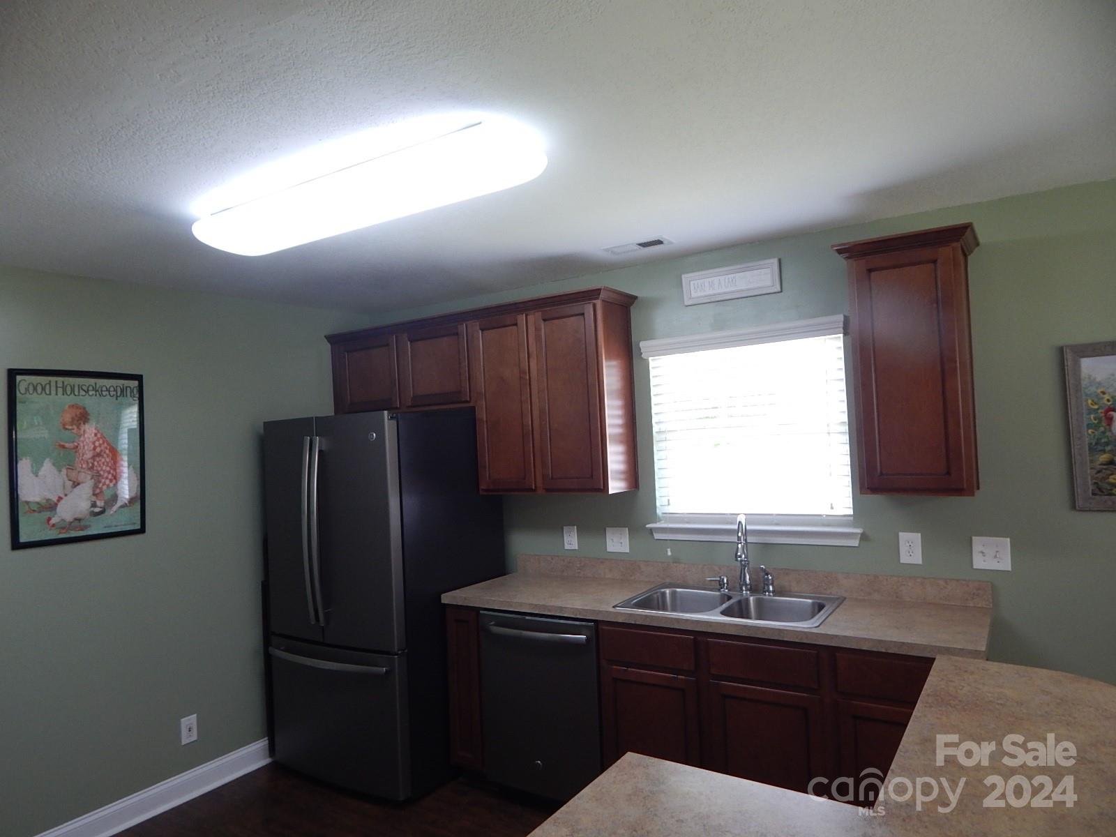 300 Ashmont Drive Kannapolis, NC 28081 - Photo 7 of 42 a kitchen with a sink a refrigerator and cabinets