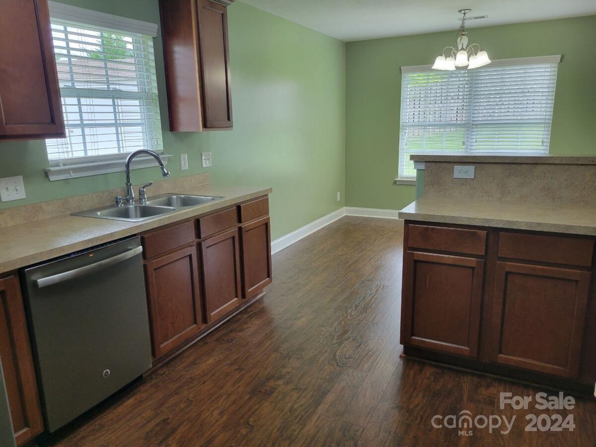 300 Ashmont Drive Kannapolis, NC 28081 - Photo 10 of 42 a kitchen with a sink cabinets and wooden floor