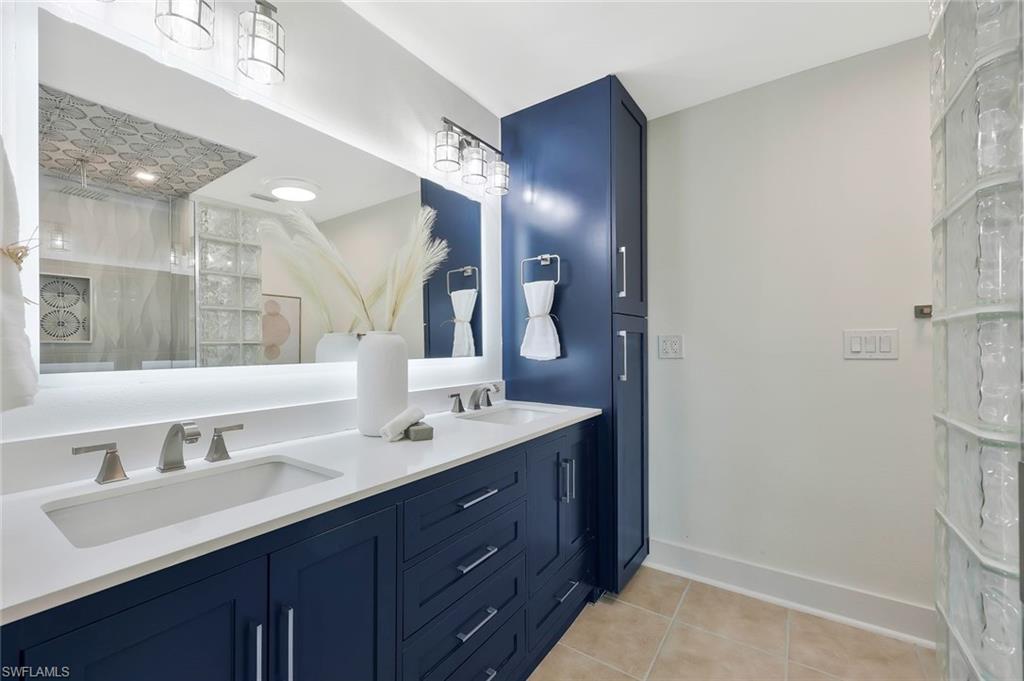 6325 Park Road Fort Myers, FL 33908 - Photo 17 of 46 a bathroom with a double vanity sink and a mirror