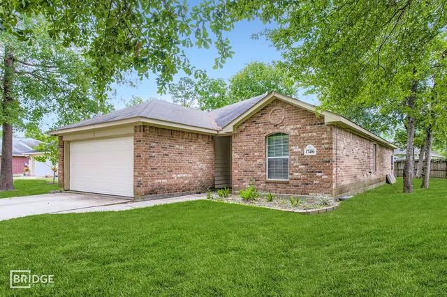 a front view of house with yard and green space