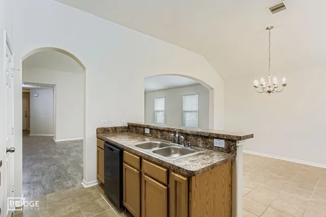 a utility room with a sink and a mirror