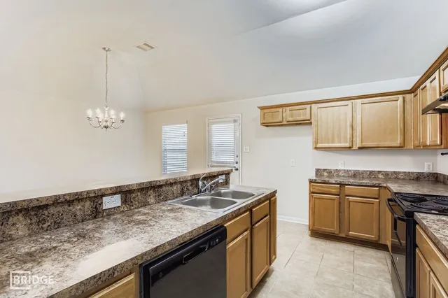a kitchen with stainless steel appliances granite countertop a sink stove and cabinets