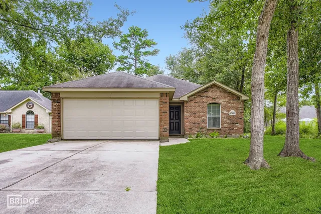 a front view of a house with yard and green space