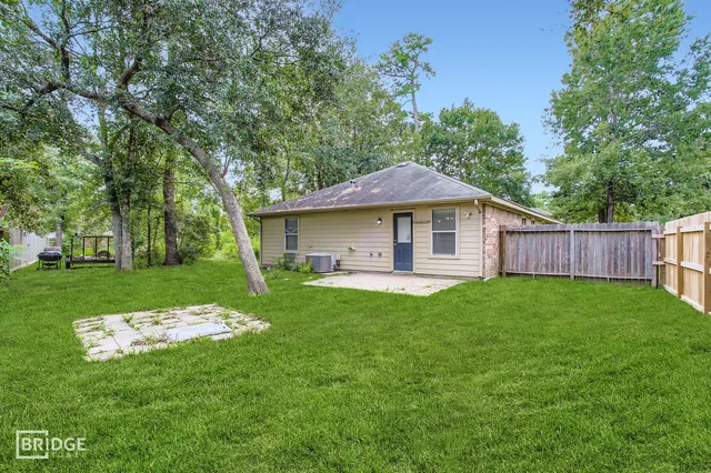 a backyard of a house with table and chairs