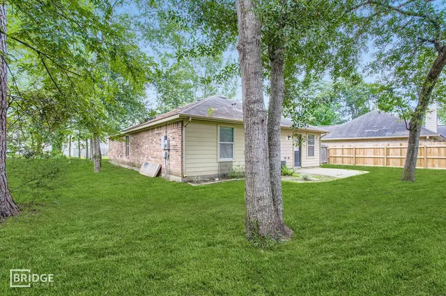 a view of backyard with a garden and trees