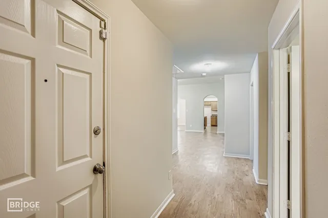 a view of a hallway with wooden floor and staircase
