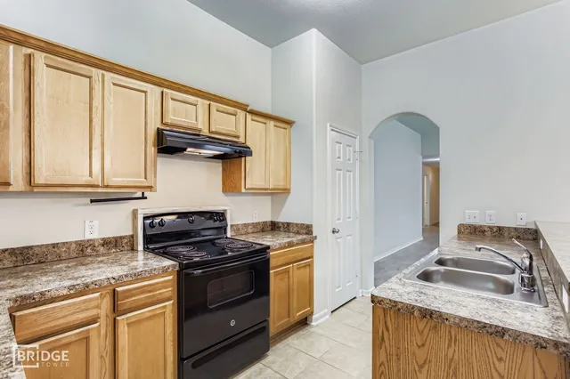a kitchen with stainless steel appliances granite countertop a stove and a sink