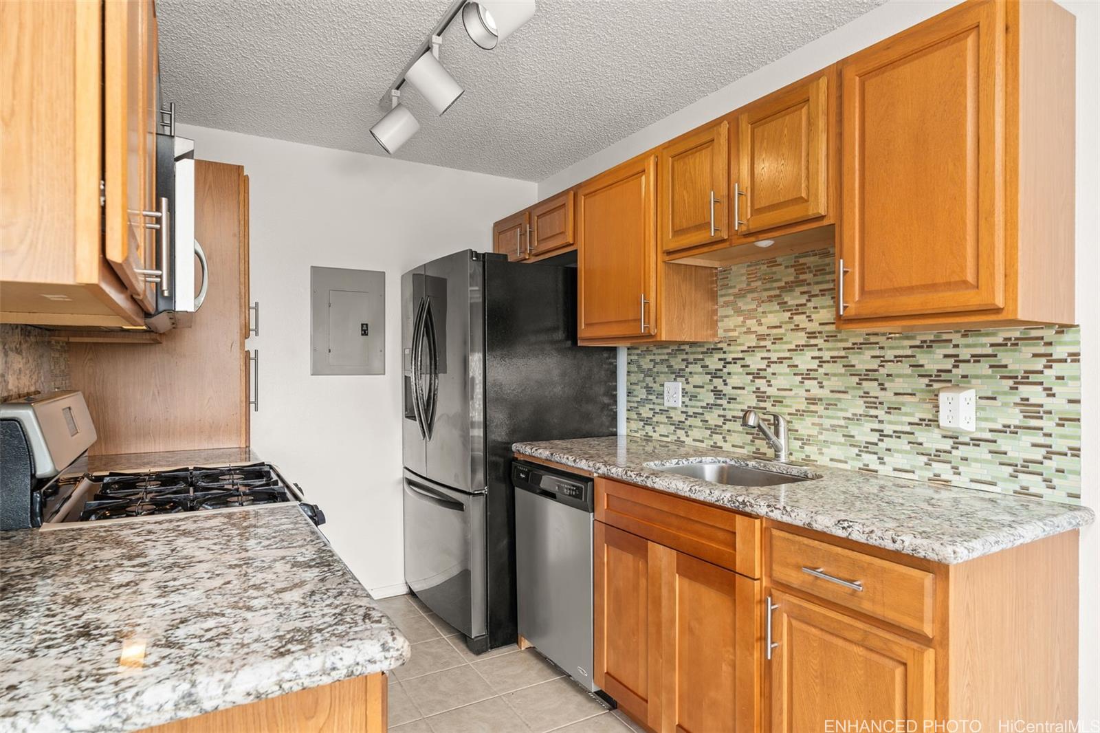 91-1119 Mikohu Street, Unit 28S Ewa Beach, HI 96706 - Photo 1 of 19 a kitchen with stainless steel appliances granite countertop a sink stove and refrigerator