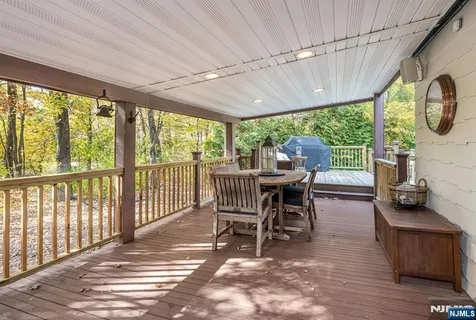 a dining room with furniture a chandelier and wooden floor