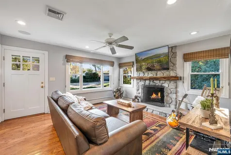 a living room with furniture fireplace and window