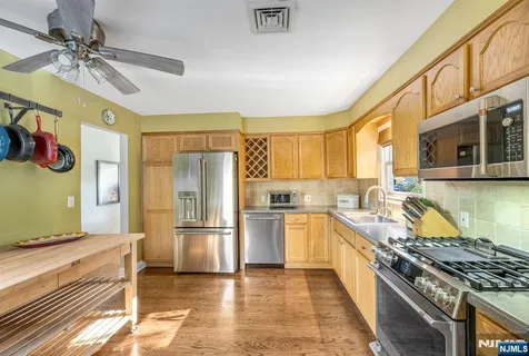 a kitchen with stainless steel appliances a refrigerator and a stove top oven