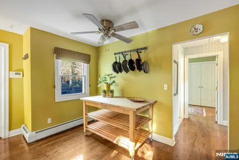 a kitchen with a sink cabinets stainless steel appliances and a window