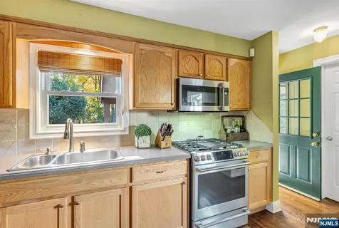 a kitchen with a stove a sink and a microwave