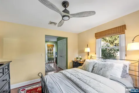 a bedroom with bed and a window