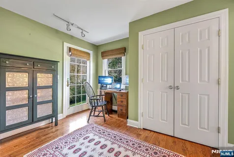 a dining room with furniture a chandelier and wooden floor