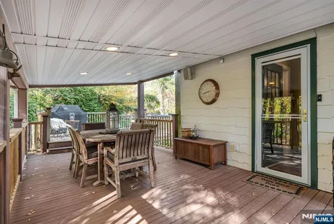 a view of a dining room with furniture large windows and wooden floor