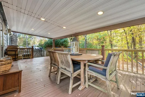 a view of backyard with deck and wooden floor