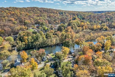 a aerial view of residential house with swimming pool and lawn chairs