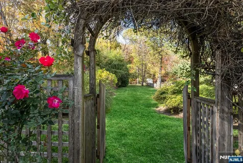 a flower garden is sitting in front of a house