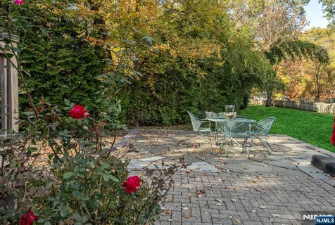 a view of a bench in the garden of a house