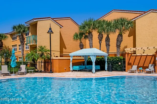 a backyard of a house with barbeque oven table and chairs
