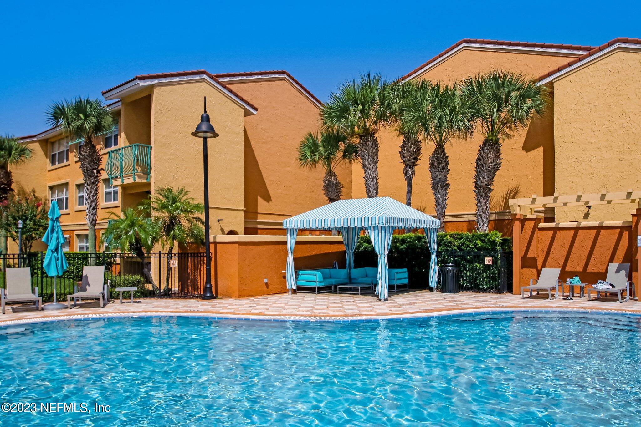 a backyard of a house with barbeque oven table and chairs