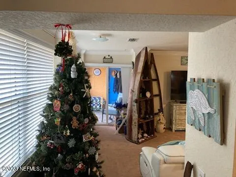 a view of living room with furniture and a rug