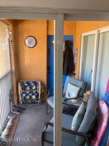 a bedroom with a bed a mirror on dresser and a flat screen tv