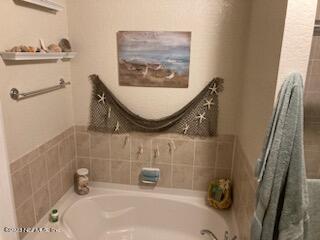 201 25th Avenue South, Unit N32 Jacksonville Beach, FL 32250 - Photo 16 of 38 a bathroom with a sink and a mirror