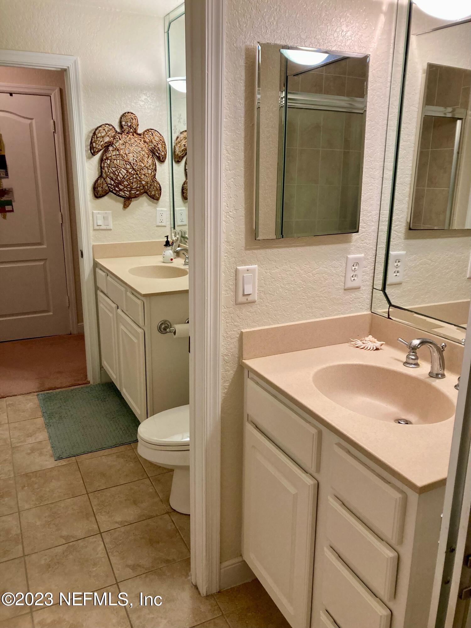 201 25th Avenue South, Unit N32 Jacksonville Beach, FL 32250 - Photo 18 of 38 a bathroom with a sink toilet and mirror