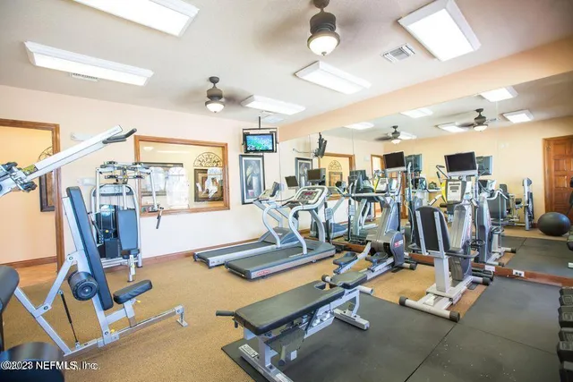a view of a balcony with chairs and wooden floor