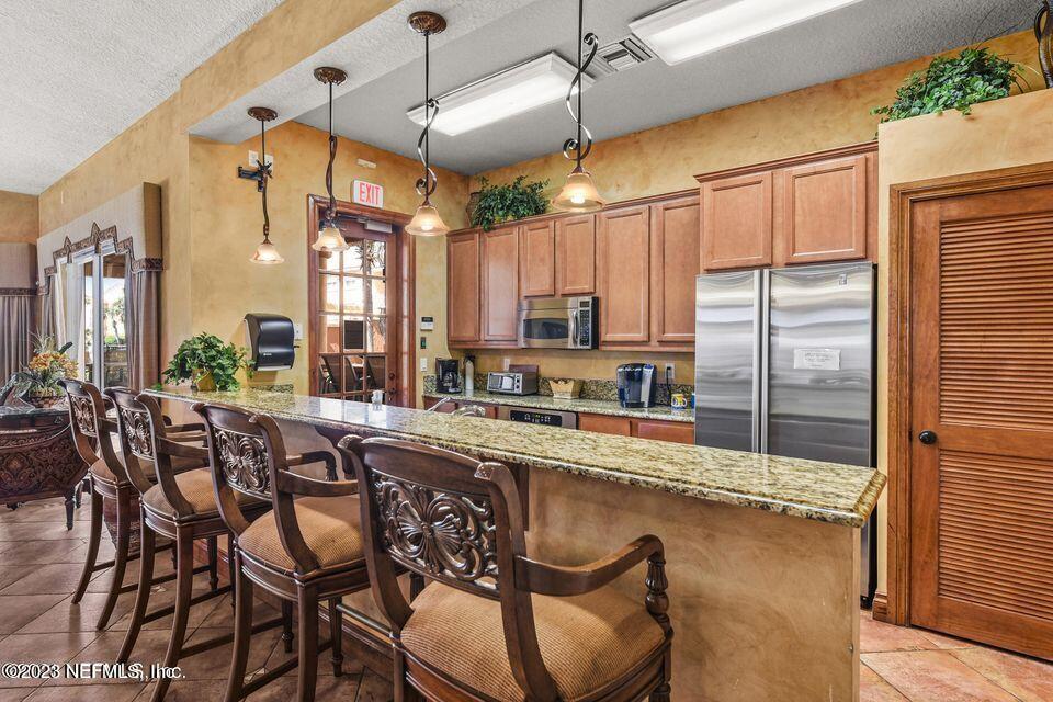 201 25th Avenue South, Unit N32 Jacksonville Beach, FL 32250 - Photo 29 of 38 a large kitchen with a table and chairs