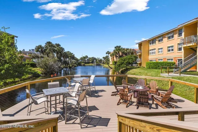 a view of multiple house with a yard and potted plants