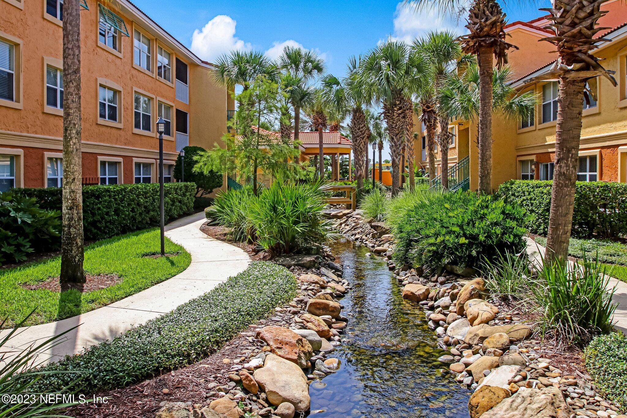 201 25th Avenue South, Unit N32 Jacksonville Beach, FL 32250 - Photo 38 of 38 a view of a brick building next to a yard