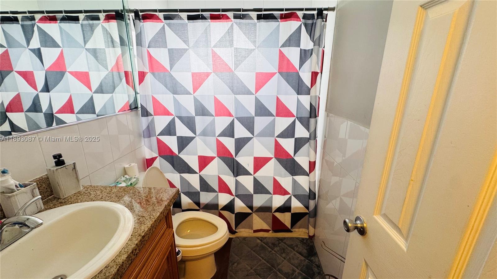 7226 Southwest 94th Place, Unit F7 Miami, FL 33173 - Photo 11 of 23 a bathroom with a sink toilet and shower curtain