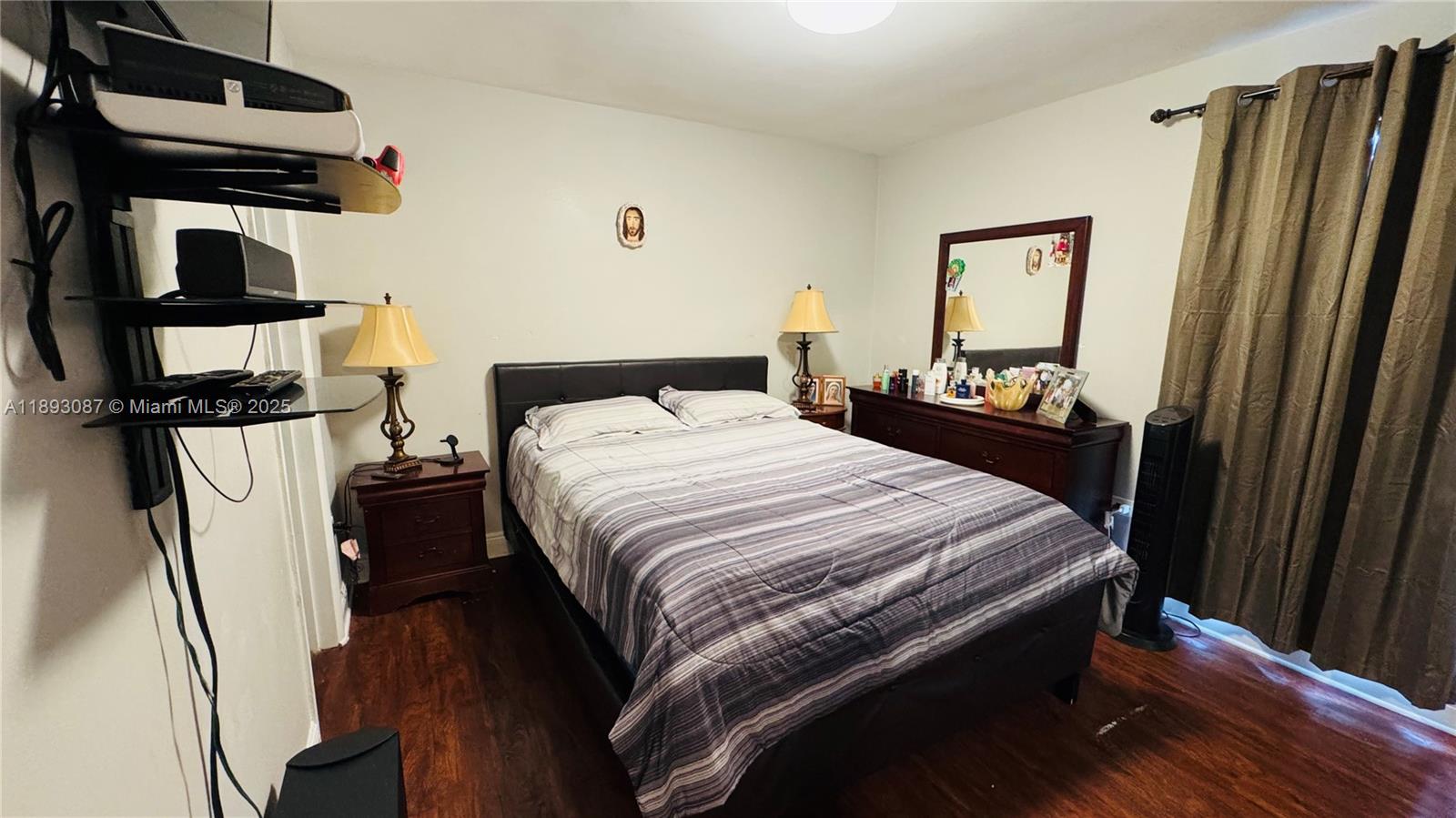 7226 Southwest 94th Place, Unit F7 Miami, FL 33173 - Photo 12 of 23 a bed sitting in a bedroom next to a window