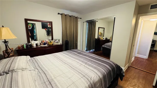 a bedroom with a bed and a large mirror