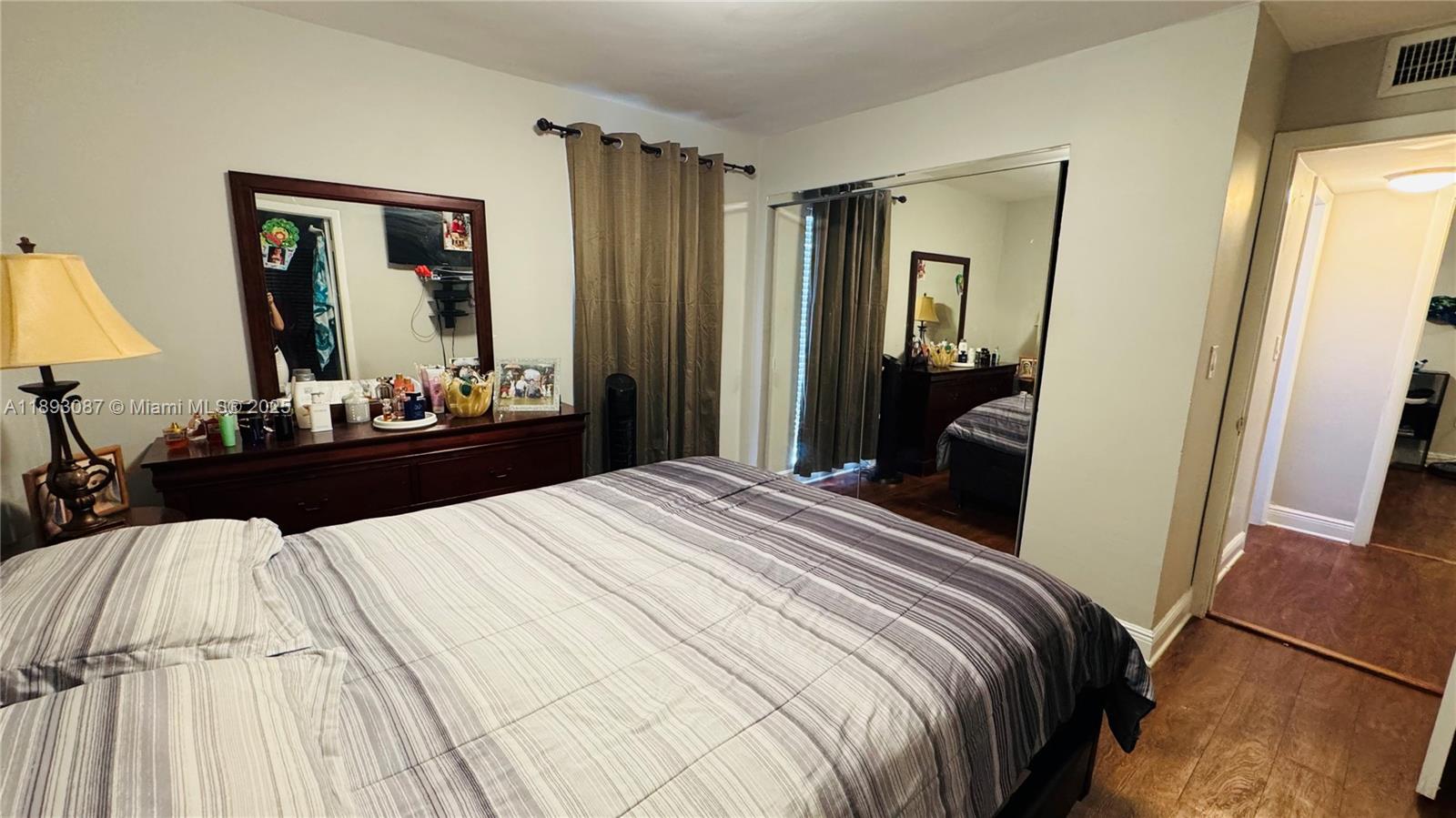 7226 Southwest 94th Place, Unit F7 Miami, FL 33173 - Photo 13 of 23 a bedroom with a bed and a large mirror