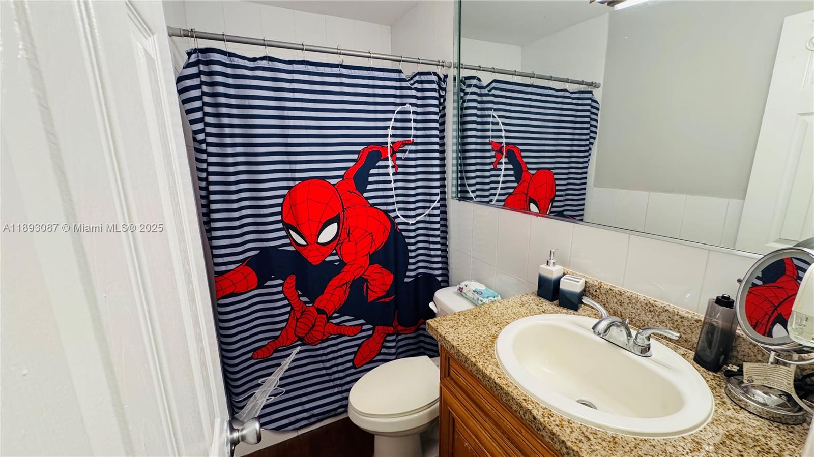 7226 Southwest 94th Place, Unit F7 Miami, FL 33173 - Photo 14 of 23 a bathroom with a sink toilet and mirror